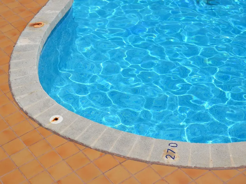 Curved pool edge with bullnose coping and a terracotta tile deck in Escondido